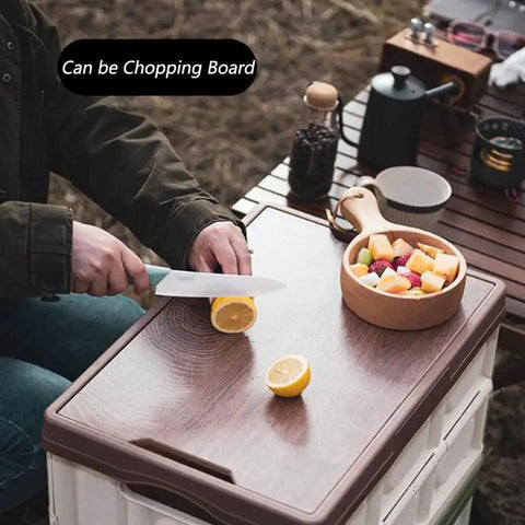Person cutting lemon on Heavy Duty Collapsible Storage Bins With Lid, Tough Camping Organizer Box For Car Trunk And Groceries.