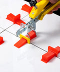 Ultra Thin 0.5mm Tile Leveling System With 2000 Spacers For Floor And Wall Installations Compatible With Most Wedges Thinnest Spacers For Narrow Grout Joints Pro Grade Kit shown in use with tile pliers and spacers on white tiles.