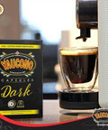 Your Go To Dark Roast Espresso Capsules 18 Count Pack Compatible With Nespresso Machines 100 Percent Puerto Rican Coffee Resealable Box Smooth Balanced Full Bodied Bold Flavor next to espresso machine.