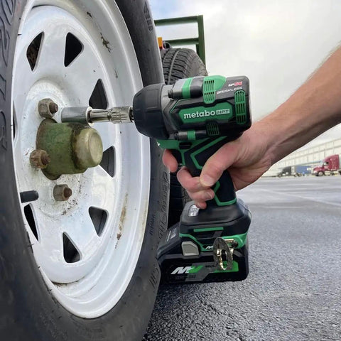36V MultiVolt Half Inch Mid Torque Cordless Impact Wrench tightening wheel bolt on vehicle