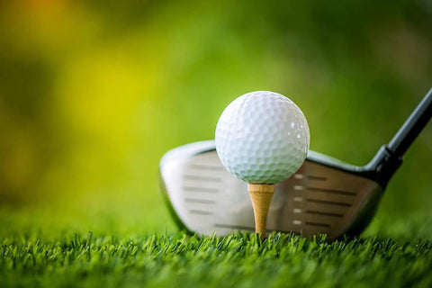 Golf club ready to strike ball on Pro Grade Bamboo Golf Tees Two And Three Quarters Inch Pack Of One Hundred Built To Last On The Course