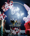 Bride To Be Neon Sign For Wall Decor LED Neon Light For Bachelorette Party Engagement Party Birthday Bash Bar Home Decor White Glow Dimmer 50 By 50 Cm Neon Light Party Ready Vibe above festive decor with pink and white balloons flowers and a drink cart
