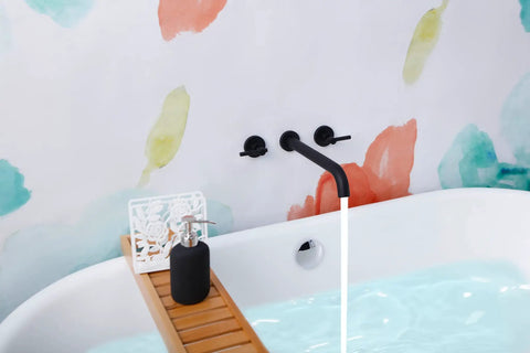 Wall Mount Tub Filler With Two Handles, Extra Long 11 Inch Spout Reach, High Flow Bathtub Faucet, Brass Rough In Valve Included, Matte Black Finish, Lead Free Brass against colorful wall
