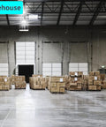 Warehouse interior with stacked boxes and high ceilings, featuring loading doors and bright overhead lights.