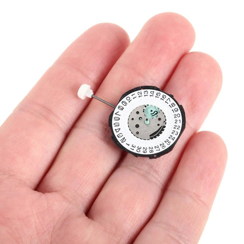 Six Piece Quartz Watch Movement Replacement Parts Kit Sl28 shown in hand for size reference