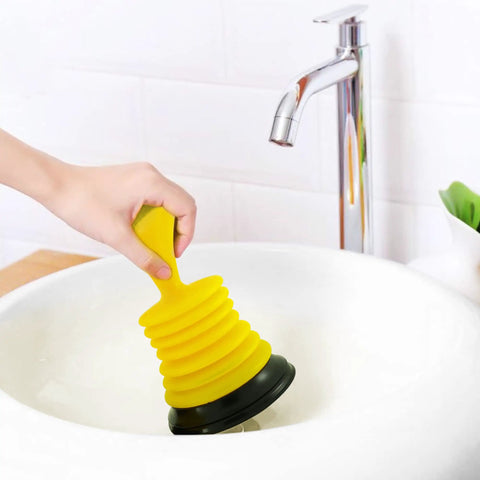 Hand using Tiny 7 Inch Sink Plunger With Ergonomic Grip No Sweat Mini Clog Remover For Kitchen And Bathroom Drains Bright Yellow