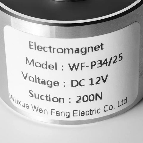 Close-up of 12V DC Electric Lifting Magnet Electromagnet Solenoid For Assembly Line Use, model WF-P34/25 label, silver tone.