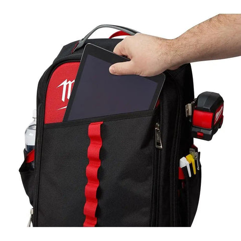 Badass Low Profile Backpack With Twenty Two Pockets And Heavy Load Bearing Harness For Tradesmen Ballistic Canvas Build tablet being inserted into front pocket
