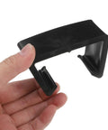 Hand holding a black adjustable clip, part of the Four Pack Outdoor Furniture Clips For Woven Sectionals, Black Adjustable Sofa Connectors.