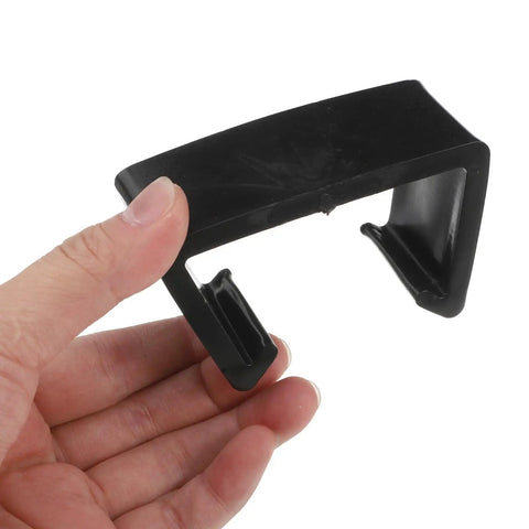 Hand holding a black adjustable clip, part of the Four Pack Outdoor Furniture Clips For Woven Sectionals, Black Adjustable Sofa Connectors.