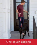 Person using Aura Bluetooth Programmable Keypad Door Lock Deadbolt With SmartKey Security, Venetian Bronze Finish, on front door with dog.