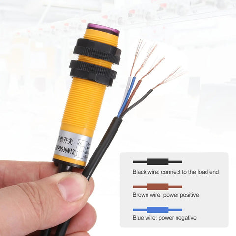 Industrial Diffuse Reflection Photoelectric Sensor M18 held with wiring diagram displayed for installation