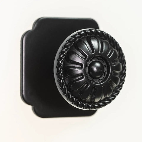 Close-up of 9 Pack Matte Black Cabinet Knobs 1.25 Inch Round Zinc Pulls With Victorian Floral Pattern For Farmhouse Kitchens.