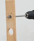 Close-up of a drill with a spade bit cutting through wood, from the 13 Piece Spade Drill Bit Set For Woodworking, Paddle Bits With Quick Change Shank, Carbon Steel Heat Treated For Durability, Sizes 1/4 To 1-1/2 Inch, Includes Nylon Storage Pouch, Built Tough For Pro Level Cuts GMTOOLS.