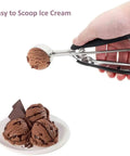 Hand using Go To 2 Tbsp Cookie Scoop Ice Cream Scooper With Trigger Release 18 8 Stainless Steel dough scoop for chocolate ice cream