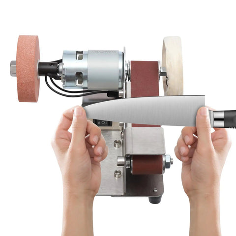 No Hassle Workhorse Mini Belt Sander And Knife Sharpener in use sharpening a knife with motor and sanding belt visible.