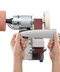 Top Shelf 3 In 1 Mini Belt Sander With 7 Speed Variable Control Bench Grinder sharpening a knife with hands holding the blade.