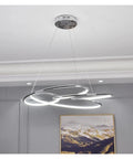 Slick Minimalist Iron Pendant Light For Kitchen And Office With Warm Led Bulb Large 74 Cm Wide Chrome and Gold Finish Contemporary Ceiling Lamp hanging above a modern space.