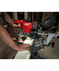 User operating Ultra Portable Aluminum Folding Miter Saw Stand with universal mounting brackets, supports 500 lbs, extends 100 inches.