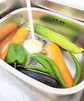 Big 9.9L Stainless Steel Dishpan For Everyday Kitchen Cleanup with vegetables being washed under running water, rustproof basin
