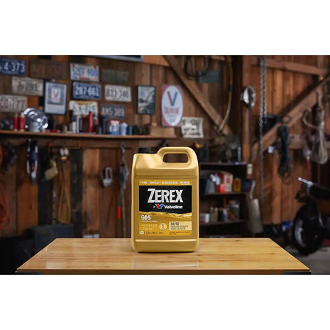 Hybrid G05 Coolant Antifreeze 50/50 Pre Mixed Six Gallon Container displayed on a wooden table in a garage setting.