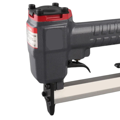 Close-up of Compact Pneumatic Brad Nailer With 100 Nail Capacity And Dry Fire Guard, showcasing aluminum frame and nose catch.