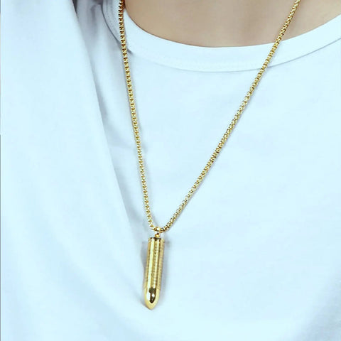 Gold Bullet Pendant Necklace With Engraved Cross And Bible Charm Premium Stainless Steel Unisex Jewelry worn on white shirt.