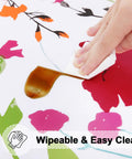 Round Fitted Tablecloth With Elastic Edge No Slip Snug Fit Waterproof Oil Proof Vinyl Backed Table Cover For 36 To 44 Inch Round Tables Perfect For Dinner Outdoor Picnic Flowers being wiped clean