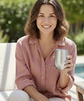 Woman enjoying a Stainless Steel Double Wall Vacuum Insulated Wine Tumbler by a poolside, perfect for hot or cold beverages.