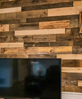 Reclaimed Wood Plank Set For DIY Rustic Accent Wall With Multi Width And Color Kiln Dried And Easy To Install Vintage Vibe From WWII Shipping Containers 10 Sq Ft Coverage Ideal For Home Renovation And Farmhouse Decor on a living room wall behind a TV