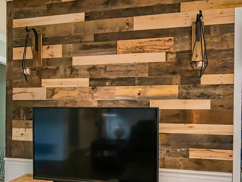 Reclaimed Wood Plank Set For DIY Rustic Accent Wall With Multi Width And Color Kiln Dried And Easy To Install Vintage Vibe From WWII Shipping Containers 10 Sq Ft Coverage Ideal For Home Renovation And Farmhouse Decor on a living room wall behind a TV