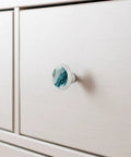 Level Up Your Space With These Seriously Dope 4 Pack Marble Look Cabinet Knobs, Featuring Smooth Round Shapes That Give Any Drawers Or Dressers A Fresh New Vibe Including Mounting Screws For Easy Installation on white cabinet.