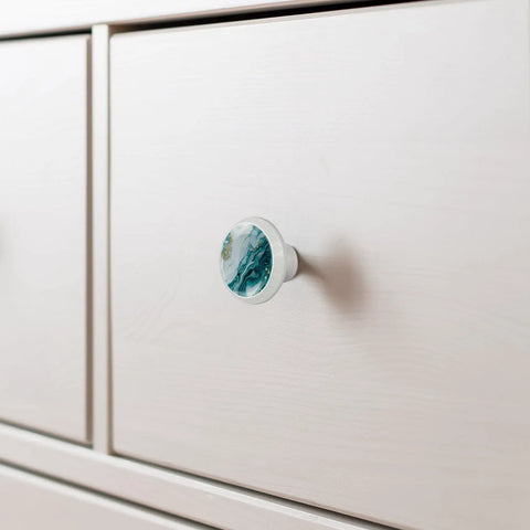 Level Up Your Space With These Seriously Dope 4 Pack Marble Look Cabinet Knobs, Featuring Smooth Round Shapes That Give Any Drawers Or Dressers A Fresh New Vibe Including Mounting Screws For Easy Installation on white cabinet.