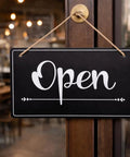 Open Closed Sign For Biz 12x8 Inch PVC Plastic Double Sided Hanging Sign, showing 'Open' on a door of a retail store.