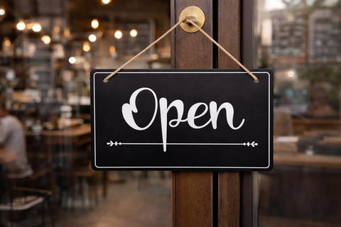 Open Closed Sign For Biz 12x8 Inch PVC Plastic Double Sided Hanging Sign, showing 'Open' on a door of a retail store.
