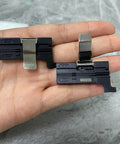 Hand holding 3 In 1 Fiber Cleaver, Fiber Holder And Fiber Fixture Clamp For FTTH 250um 900um Cables, Aluminum Alloy Construction, Black Finish