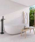 Freestanding Matte Black Bathtub Faucet With Waterfall Spout And Hand Shower Floor Mounted Brass Tub Filler in modern bathroom scene