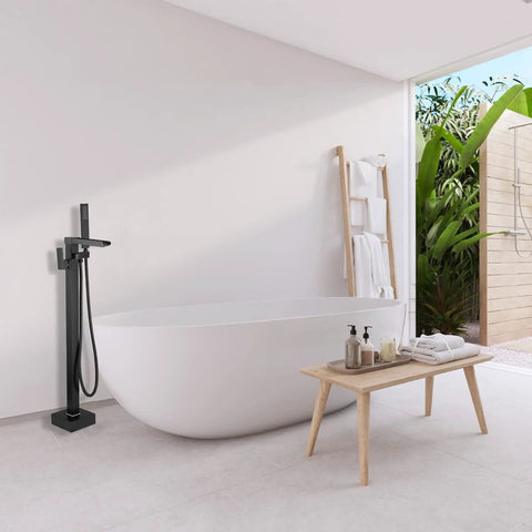 Freestanding Matte Black Bathtub Faucet With Waterfall Spout And Hand Shower Floor Mounted Brass Tub Filler in modern bathroom scene