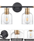 Dual Matte Black Wall Sconce Lights For Bathrooms With Clear Glass Shades And Antique Brass Finish, front view, bulb detail.