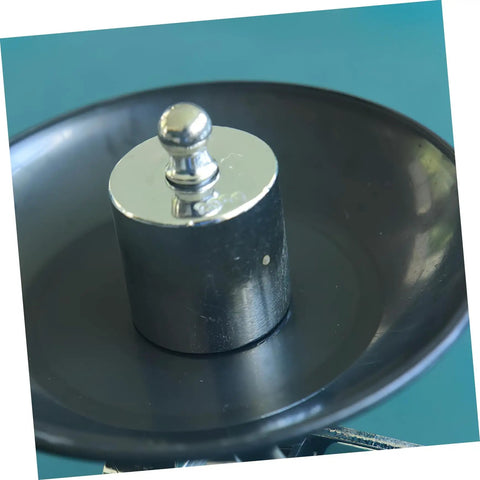 High Precision Calibration Weights For Digital Scales And Lab Use showing single metal weight on dark dish