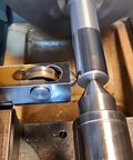 Installed mini lathe burnishing tool on tool post, smoothing a steel workpiece surface