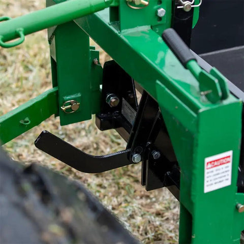 Close-up of green 3 Point 10 Cu Ft Dump Box For Category 1 Tractors with quick hitch lock and black lever