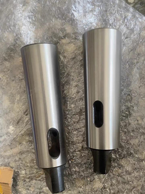 Two steel Morse taper adapter sleeves (2/3) for lathes and drill presses, front and side views.