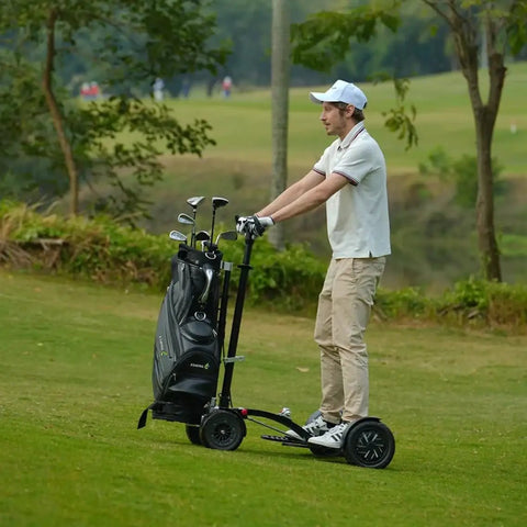 Electric Four Wheel Foldable Golf Cart Trolley With Easy Push Or Ride Options In Classic Black Trim on grassy golf course.