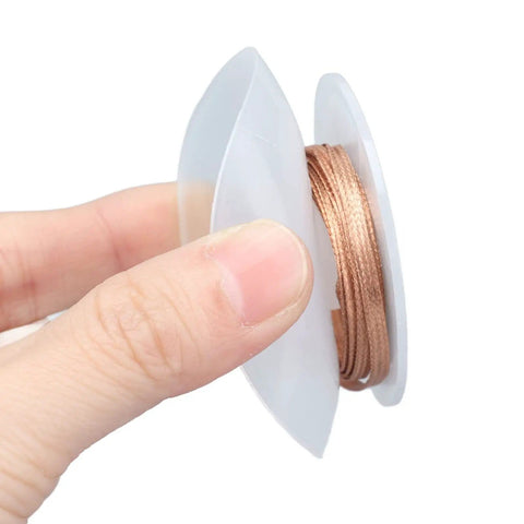 Person holding Pro Grade Desoldering Wire Kit With Alloy Copper Solder Wick For Electronics Repair and PCB Maintenance, 1.5 meter length.