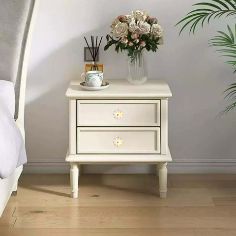 Set Of 8 Yellow And White Vintage Ceramic Drawer Knobs With Classic Spade Cabinet Door Pulls on a nightstand with decorative flowers.