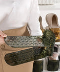 Person holding a Built Different Double Layer Shoe Slot Organizer For Closets adjustable vertical storage rack in green.