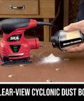 2.0 Amp 1/4 Sheet Palm Sander with Pressure Control, clear dust canister, micro-filtration system on a wooden surface