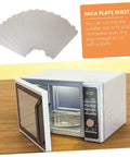 Six Pack Microwave Waveguide Mica Sheet Covers For Heat Insulation And Splatter Guard Replacement Pads next to an open microwave oven