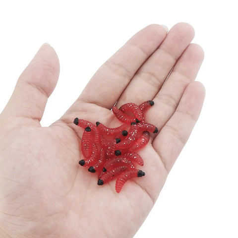 Hand holding red maggots from 250 Piece Soft Plastic Fishing Worms Lures Set Realistic Earthworm Baits For Freshwater Fishing Reusable Fake Maggots
